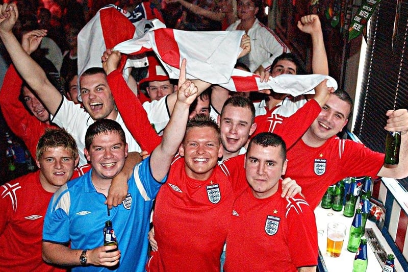 Patriotic England fans sport the team's colours in the Sports Bar during Euro 2004.