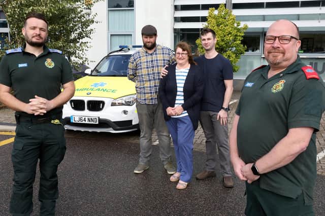 Liz Peacock and her sons Andrew and Graham, with ambulance staff Nigel Furmidge and Andrew Hill
