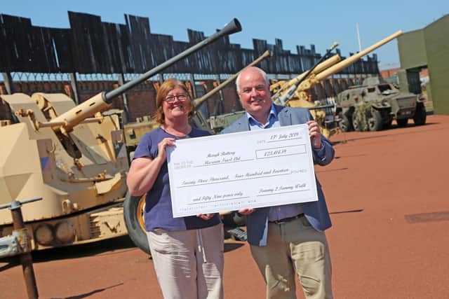 Museum manager Diane Stephens receives a cheque for over £23,000 from Councillor Dave Hunter one of the organisers of 2019's Tommy to Tommy sponsored walk. Picture: Tom Banks