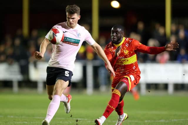 BANBURY, ENGLAND - NOVEMBER 06: Matthew Platt of Barrow battles for possession with Chris Wreh of Banbury United during the Emirates FA Cup First Round match between Banbury United and Barrow at Spencer Stadium on November 06, 2021 in Banbury, England. (Photo by Luke Walker/Getty Images)