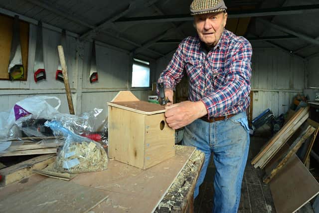 Bob says he stopped counting how many bird houses he's built after he completed the 500th one./Photo: Frank Reid