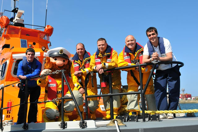 Hartlepool United footballers Fabian Yantorno and Evan Horwood stand alongside RNLI crew members  Stormy Stan, Ian Anderson, Richard Shaw and Gary Waugh in 2011.
