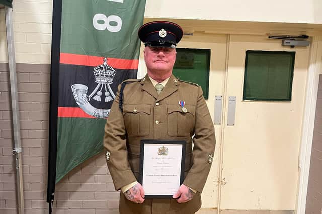 Ronnie Eve, 53, receives an award for his dedication to the Cleveland Army Cadet Force from the Lord Lieutenant of County Durham, Sue Snowdon.
