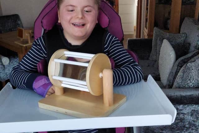 Talia is all smiles in her new chair.