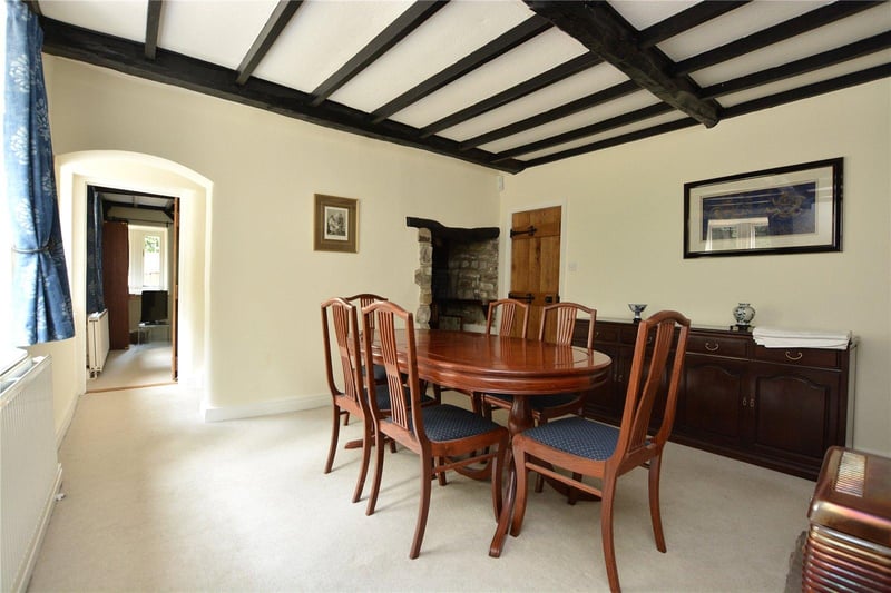 The formal dining room has a characterful feel with the dark wood ceiling beams and charming stone alcove, and provides plenty of space for entertaining.