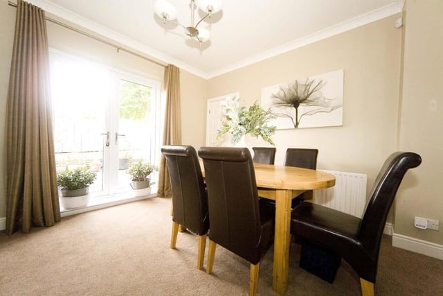The dining room has easy access to the garden via the French doors.