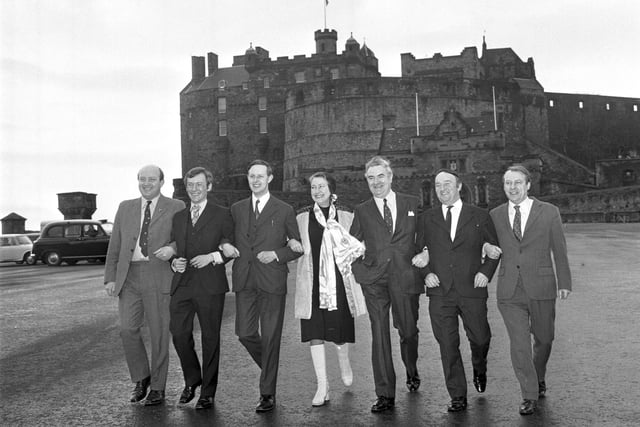 Scottish National Party MPs Iain MacCormick, George Reid, Gordon Wilson, Winnie Ewing, Donald Stewart, Hamish Watt and Douglas Henderson on Edinburgh Castle Esplanade in March 1974.