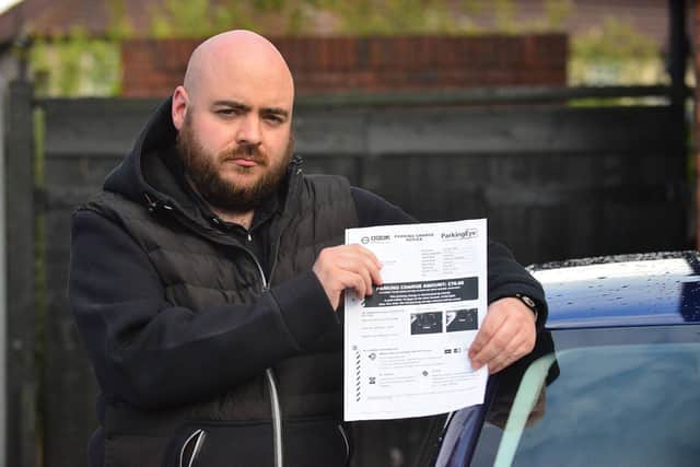 Rick Kitson with his parking fine. Picture by FRANK REID