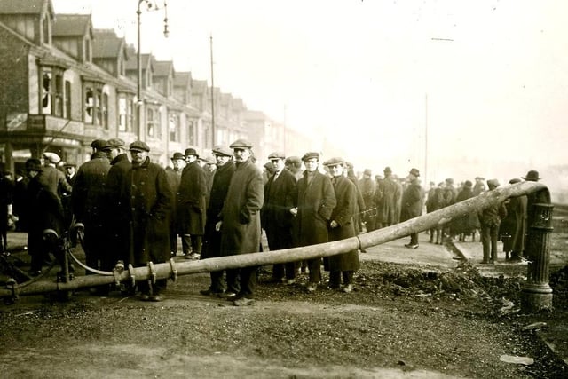 Spectators stand next to a tram line post which was damaged in the fire. Photo: Hartlepool Museum Service.
