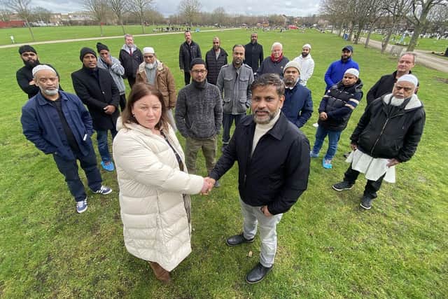 Councillor Helen Howson shakes hands with Ahsan Abul, a spokesperson from the Bangladeshi Cultural Association, with members of the BCA and other invited guests in West View Cemetery.