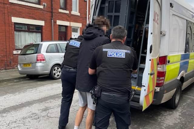 A suspect is led away after Monday's raid in Harcourt Street. (Photo: Cleveland Police).