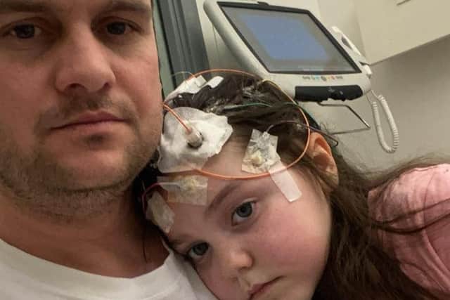 Lyla with her dad Paul during a more recent hospital stay.