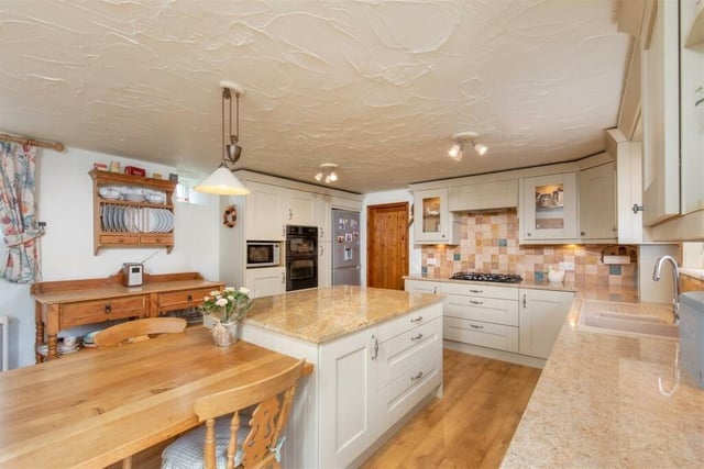 This kitchen is large and spacious, affording ample space for a dining area too.