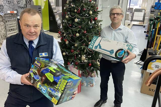 Michael Sumpter, left, and Lee Dees, from MKM Building Supplies, with the first presents donated to the Hartlepool Mail-backed 2021 Christmas gift appeal. Picture by FRANK REID