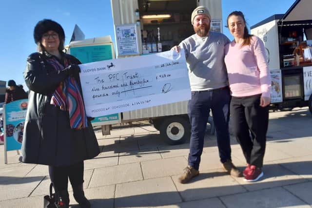 PFC Trust founder Frances Connolly, left, receives the £925 cheque from the Hungry Seagull's owners Karl Campbell and Dorota Bobe