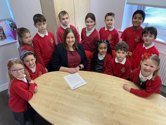 Headteacher Sarah Wassell (centre) and members of the school council celebrate their "outstanding" Ofsted rating.