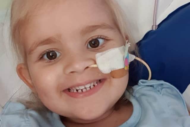 Brave Isabellah Owen smiles following hospital treatment.