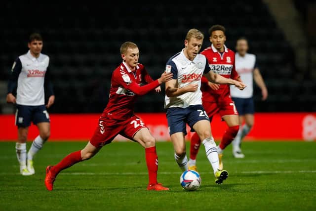 Jayden Stockley of Preston North End battles for possession with George Saville of Middlesbrough.