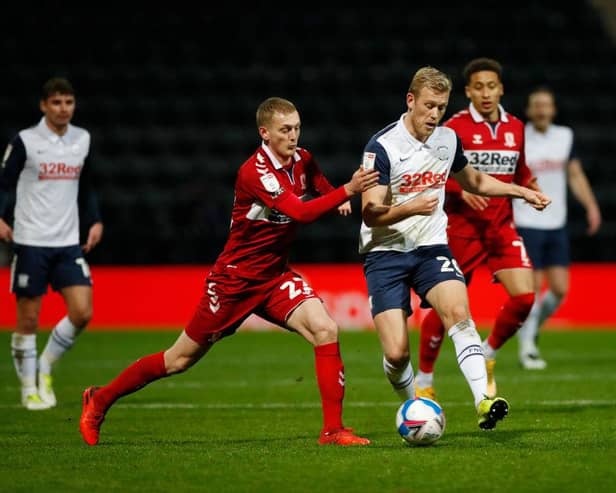 Jayden Stockley of Preston North End battles for possession with George Saville of Middlesbrough.