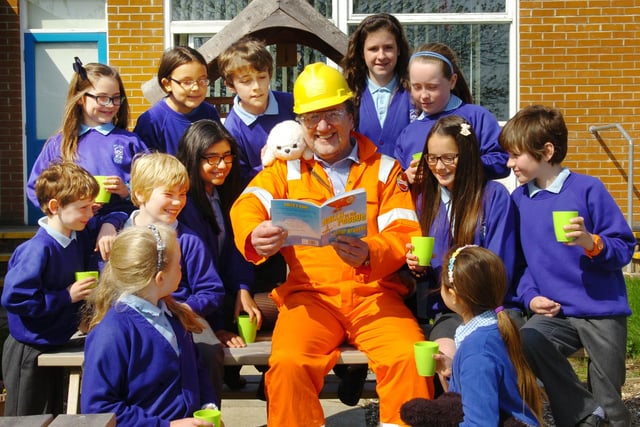 Children's author, Peter Brunton, celebrates alongside pupils after the school is awarded an eco school status.