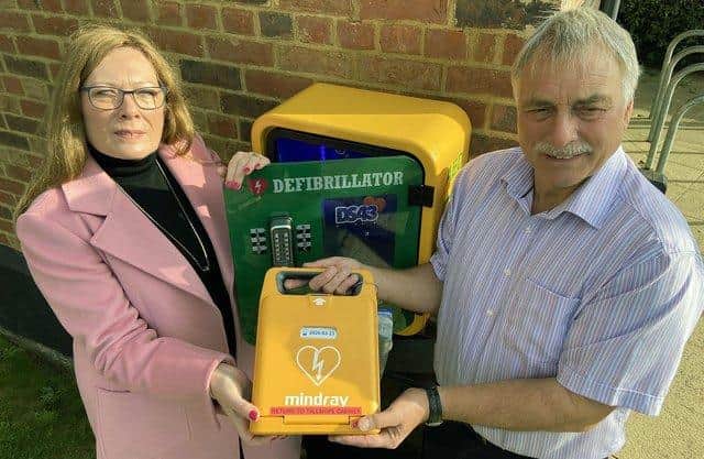 Danny Shurmer's parents, Pam and Bill Shurmer, with a recently installed Defibrillator at The Tall Ships pub.