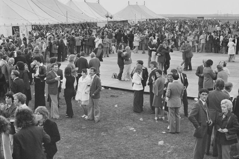 A large gathering of people standing outside three marquees at a Laing works party held at Graythorp on 21st June 1974.