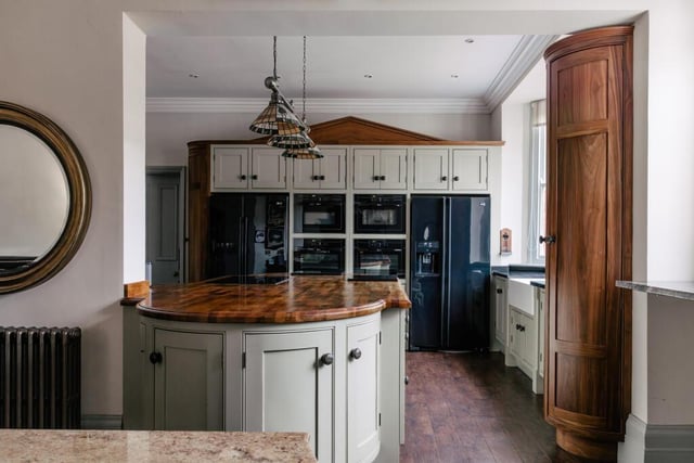 This open plan kitchen sits at the heart of the home and features a large cast iron with a working fire.