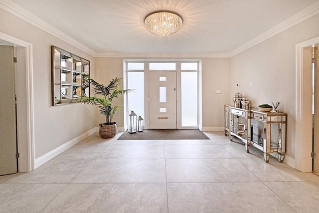 This grand entrance hall attracts plenty of natural light.