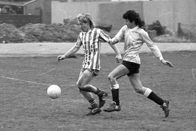 Two players sport fine mullets as they play football. Date unknown.