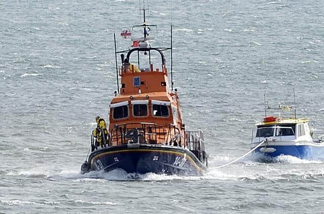 The fishing boat was towed back to safety. Picture: RNLI/Tom Collins