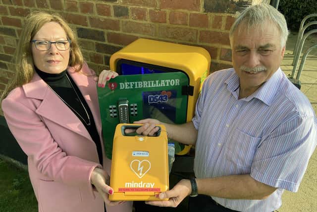 Pam and Bill Shurmer with the recently installed Defibrillator at theThe Tall Ships pub.