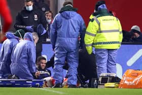 Marcus Browne of Middlesbrough receives medical treatment against Brentford.