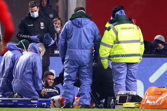 Marcus Browne of Middlesbrough receives medical treatment against Brentford.