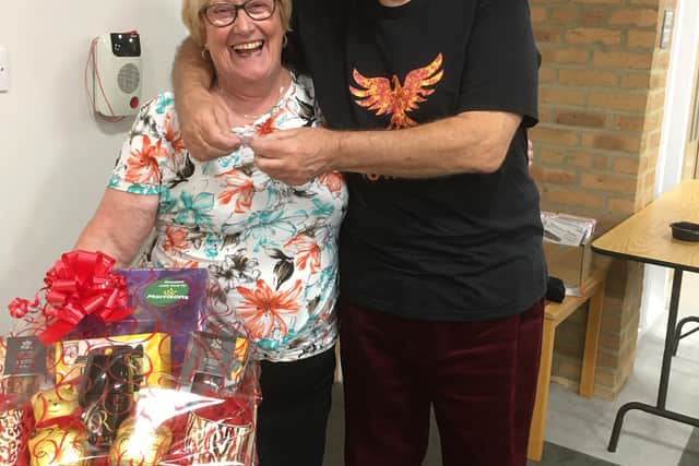 Bamburgh Court resident Carol Pounder with Derrick Rowbotham drawing the raffle to win a Morrison's hamper.