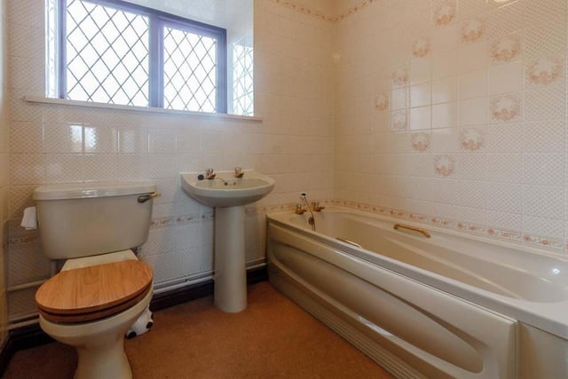 The last room to inspect at Hollies End is the family bathroom, which comprises a panelled bath, pedestal wash hand basin, low-flush WC, heated towel-rail and tiled walls.