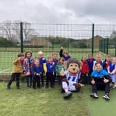Hartlepool United mascot Victoria and loan player Dan Kemp with Throston Primary School pupils.