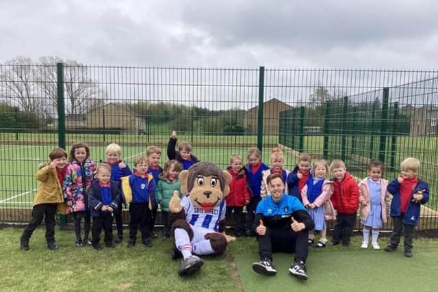 Hartlepool United mascot Victoria and loan player Dan Kemp with Throston Primary School pupils.