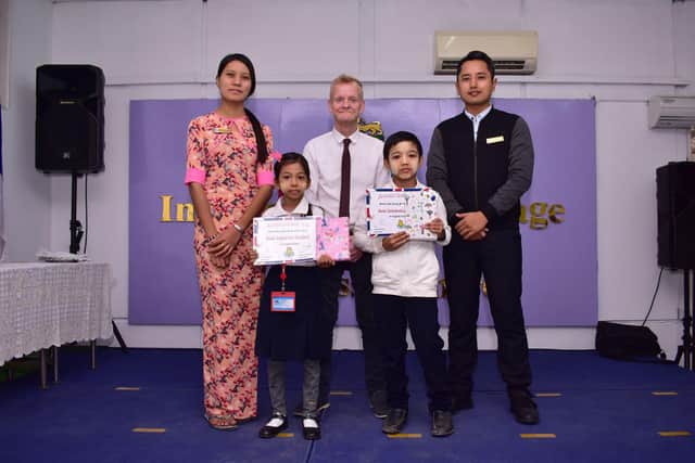 David with a fellow teacher, head of school and two students during an awards ceremony to outstanding students in Mandalay.