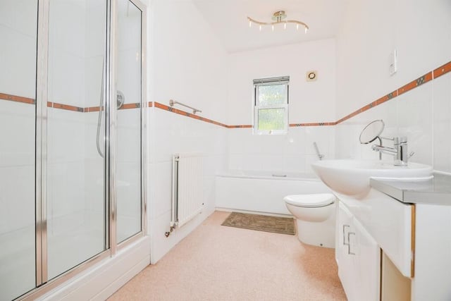 The family bathroom has a walk-in shower cubicle as well as a bath.
