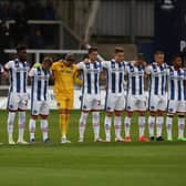 Hartlepool United's players stand in silence in memory of former player Lenny Johnrose who passed away this week during the Sky Bet League Two match between Hartlepool United and Tranmere Rovers. (Credit: Mark Fletcher | MI News)
