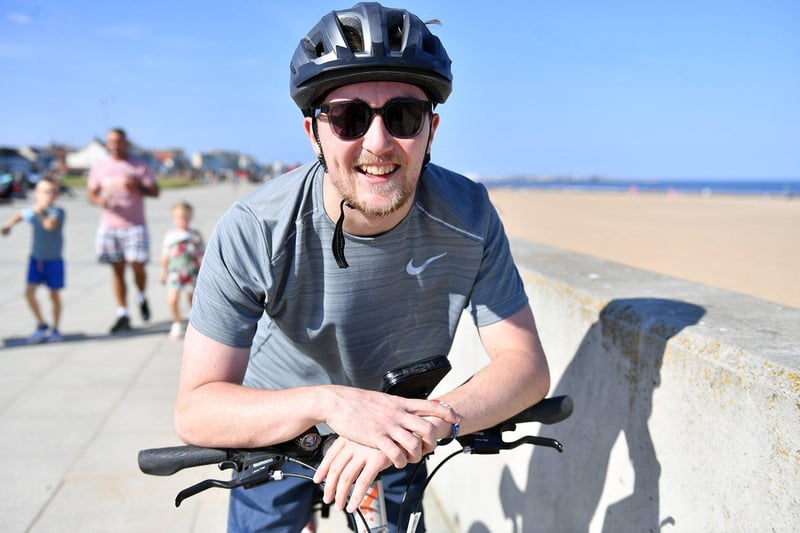 Adam Davison stops to have his picture taken and enjoy the sun at Seaton Carew. Picture by FRANK REID.