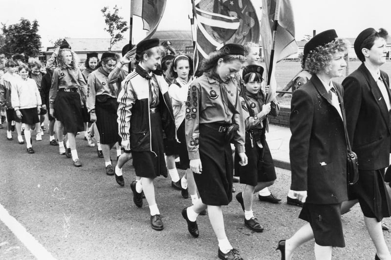 Can you spot someone you know among these Girl Guides marching under their banners en route to St Paul's Church?