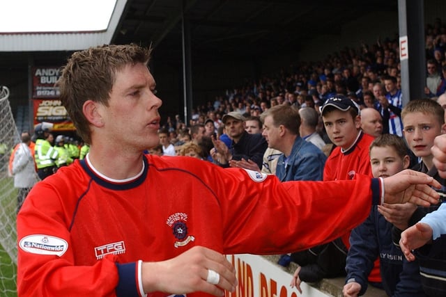 The 2003 promotion was an odd occasion given that Hartlepool United went up after other results went their way following a 4-0 defeat at Scunthorpe United. Midfielder Darrell Clarke is pictured speaking to fans following the defeat.