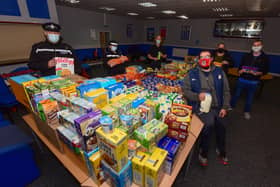 Chris Stottard Hartlepool United Club Chaplain, with members of Cleveland Police Engagement Team and Tom Harrison and Kate Simmons with some of the donations handed for the free children's meals.