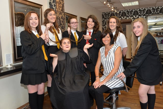 Isobel Joyce with stylist Tracy Lancaster from Liberty Hair Salon half way through her charity haircut in 2015 with her school friends Eve Readman, Katie Priest, Beth Causation, Hannah Snowdon, Jen Foreman and Olivia Bennison. Picture by FRANK REID