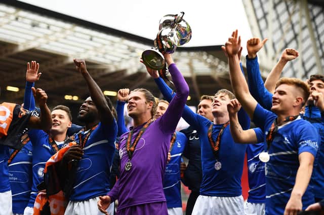 Hartlepool United players celebrate their promotion to the Football League after beating Torquay United on penalties.