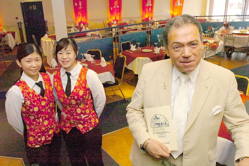 The restaurant's well-known owner David Nin in his trademark white suit and some of his staff.