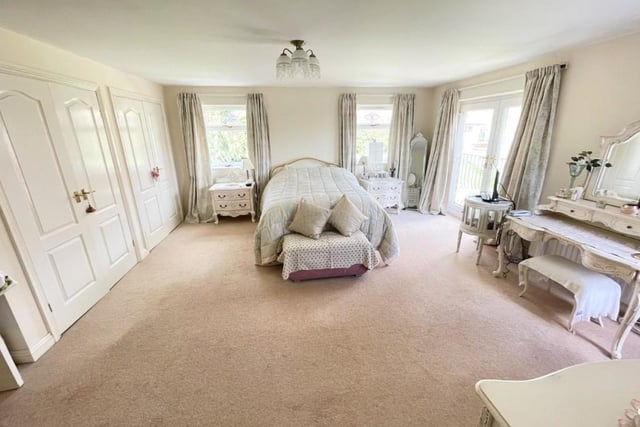 The spacious master bedroom features a 'Juliet' balcony and built-in wardrobes.