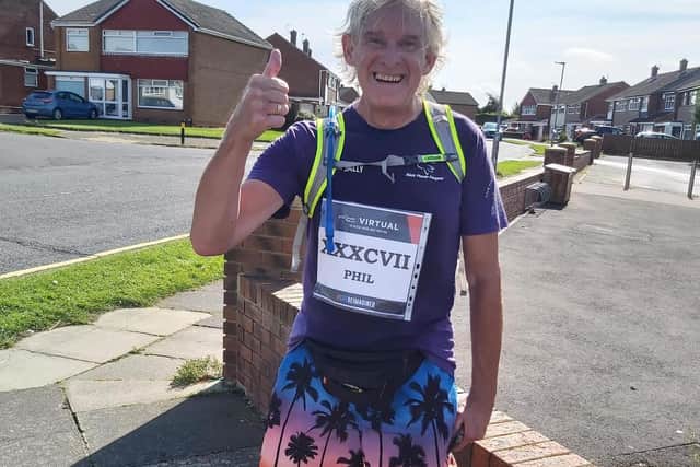 Phil Holbrook gives a thumbs up after completing the half marathon length course around Hartlepool.