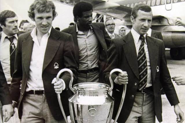 Nottingham Forrest players John McGovern (right) and Ian Bowyer carrying the European Cup after arriving home in May 1979.